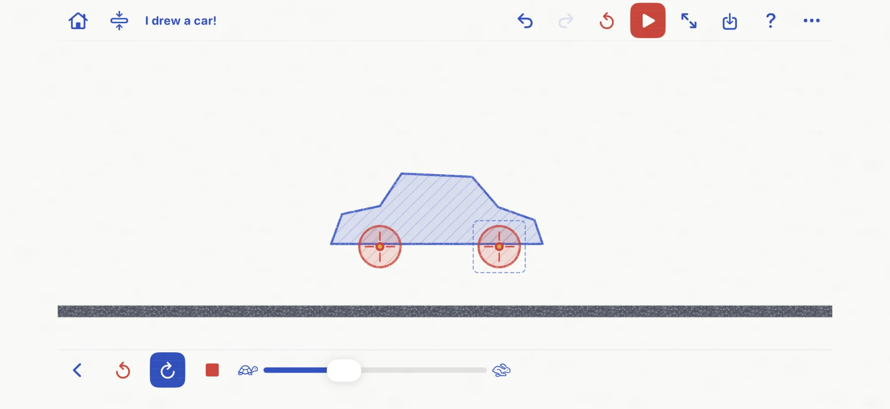 Actual Drawn to Physics workshop with a blue hand-drawn car body and two powered red wheels